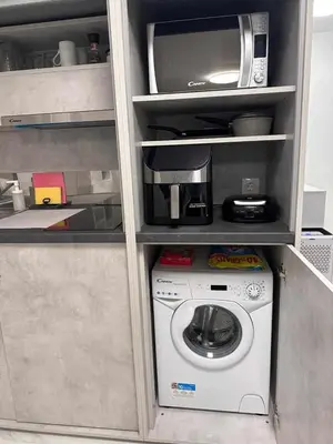 a kitchen with a washing machine and a microwave at Modern Gem in Central Athens in Athens