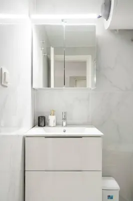 a white bathroom with a sink and a mirror at Modern Gem in Central Athens in Athens