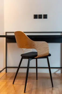 a wooden chair sitting in front of a desk at LIV - Spacious Flat for Friends & Family in Athens