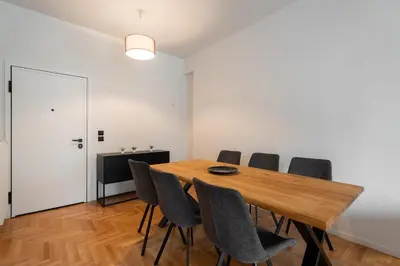 a dining room with a wooden table and chairs at LIV - Spacious Flat for Friends & Family in Athens