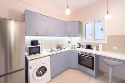 a kitchen with a washing machine and a sink at Radiant Apt near Lycabettus in Athens