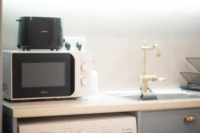 a microwave sitting on top of a kitchen counter at Radiant Apt near Lycabettus in Athens