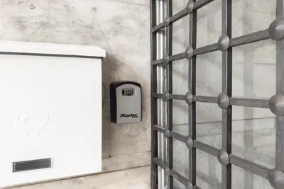 a metal wall with a cell phone sign on a wall at Radiant Apt near Lycabettus in Athens