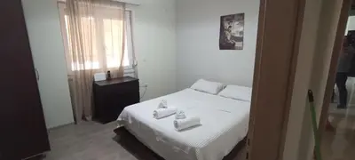 a bedroom with a bed with three towels on it at Thimarakia Maniakiou Apartment in Athens