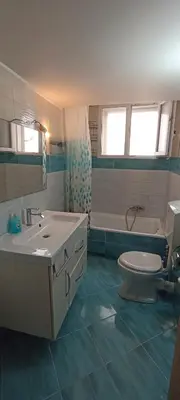 a bathroom with a sink and a toilet and a tub at Thimarakia Maniakiou Apartment in Athens