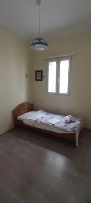 a bedroom with a bed and a window at Thimarakia Maniakiou Apartment in Athens