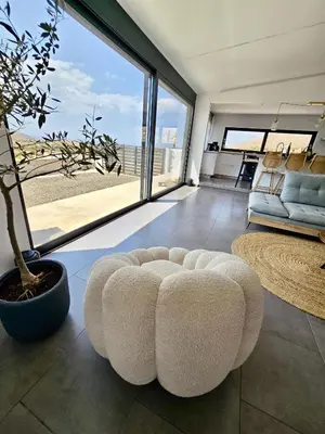 a living room with a couch and a large window at Aquarius Luxury Suites in Ólimbos