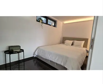 a small bedroom with a bed and a television at Aquarius Luxury Suites in Ólimbos