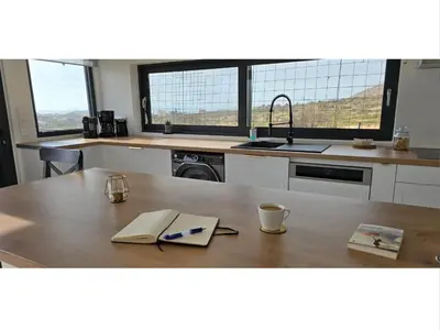 a kitchen with a table with a book on it at Aquarius Luxury Suites in Ólimbos
