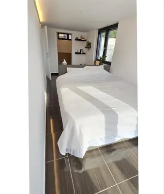 a bedroom with a large bed with white sheets at Aquarius Luxury Suites in Ólimbos