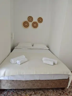 a bed with two towels on it in a room at Aspa and Alex penthouse retreat in Koropíon