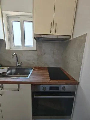 a kitchen with a sink and a counter top at Aspa and Alex penthouse retreat in Koropíon
