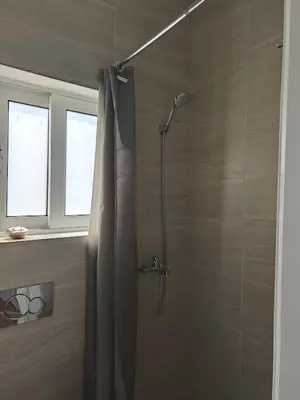 a shower with a shower curtain in a bathroom at Aspa and Alex penthouse retreat in Koropíon