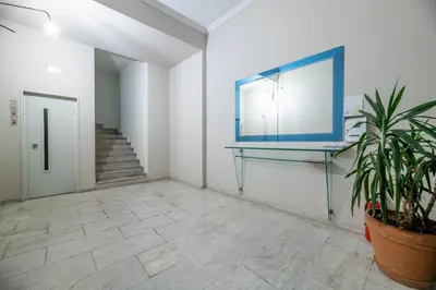 a hallway with a mirror and a potted plant at Aphrodite - Luxenia Suites in Athens
