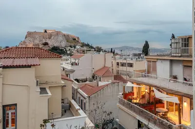 a view of the roofs of buildings in a city at Aphrodite - Luxenia Suites in Athens