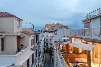 a view of a city with a mountain in the background at Aphrodite - Luxenia Suites in Athens
