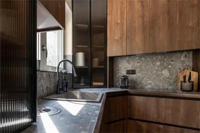 a kitchen with a sink and wooden cabinets at Annasa Apartments in Athens