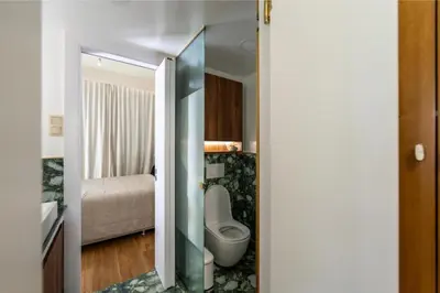 a bathroom with a toilet and a bed at Annasa Apartments in Athens