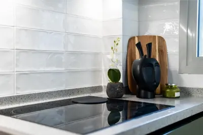 a kitchen counter with a black container with utensils at Annasa Apartments in Athens
