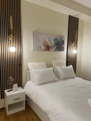 a bedroom with a white bed and a painting on the wall at Acropolis Urban sidewalk view in Athens