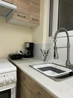 a kitchen counter with a sink in a kitchen at Acropolis Urban sidewalk view in Athens