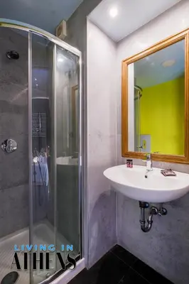 a bathroom with a sink and a shower at Spacious Apt At Historical Center Of Athens 4&2 ppl in Athens