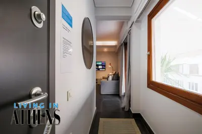 a hallway leading into a living room with a window at Spacious Apt At Historical Center Of Athens 4&2 ppl in Athens