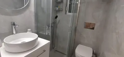 a bathroom with a toilet and a sink and a shower at Cozy Νest Athens in Athens