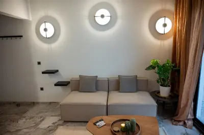 a living room with a couch and a table at Athenee Suites in Athens