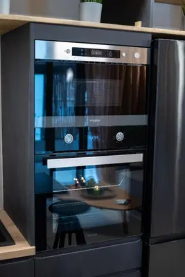 a microwave oven with a wooden plate inside of it at Athenee Suites in Athens