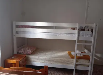 two bunk beds in a room with a ladder at White Bunk Bed in dorm 5' from metro in Athens