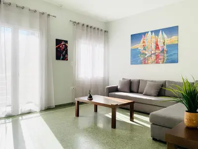 a living room with a couch and a coffee table at Acropolis Luminous Apartment in Athens