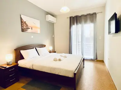 a bedroom with a bed with two towels on it at Acropolis Luminous Apartment in Athens