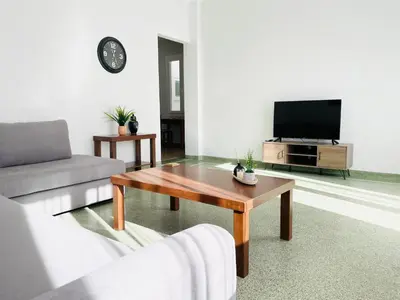 a living room with a coffee table and a tv at Acropolis Luminous Apartment in Athens