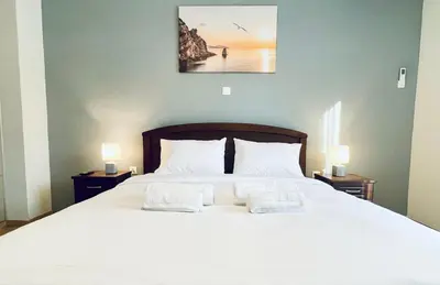 a bedroom with a large white bed with two pillows at Acropolis Luminous Apartment in Athens
