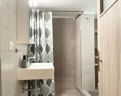 a bathroom with a sink and a shower at Acropolis Luminous Apartment in Athens