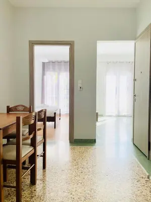 a dining room with a table and chairs and a mirror at Acropolis Luminous Apartment in Athens