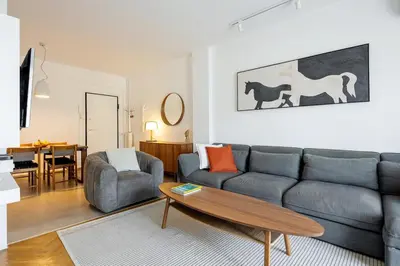 a living room with a couch and a table at Bright and breezy by the sea in Athens