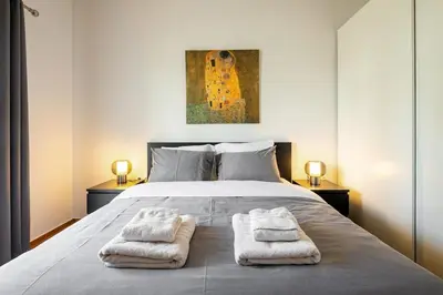 a bedroom with a bed with two towels on it at Bright and breezy by the sea in Athens