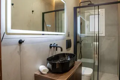 a bathroom with a sink and a shower at Luxury Suite 100m from Shore and Tram in Athens