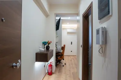 a hallway leading into a room with a desk and a chair at Luxury Suite 100m from Shore and Tram in Athens