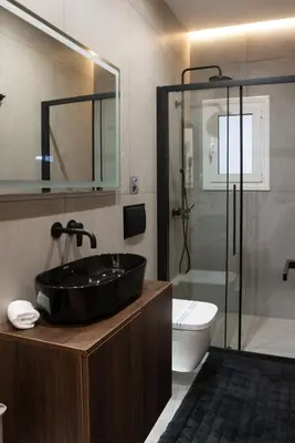 a bathroom with a black sink and a toilet at Luxury Suite 100m from Shore and Tram in Athens