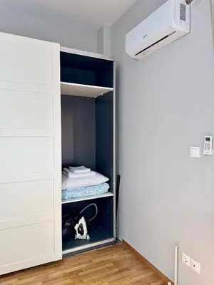 a room with a closet with a white cabinet at Kalithea Spartis appartment in Athens