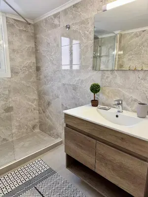 a bathroom with a sink and a shower at Kalithea Spartis appartment in Athens