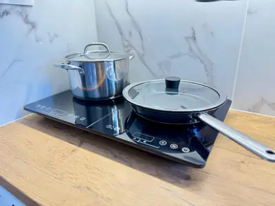 a pot and a pan sitting on top of a stove at Kalithea Spartis appartment in Athens
