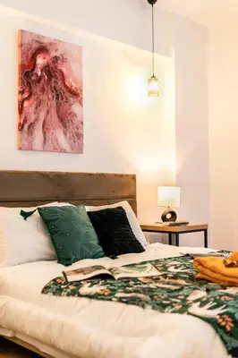 a bedroom with a bed with a book on it at Acropolis Retreat Stay in Style in Athens