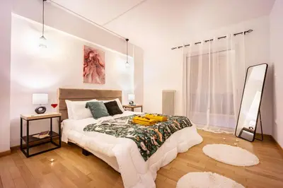 a bedroom with a large bed and a mirror at Acropolis Retreat Stay in Style in Athens