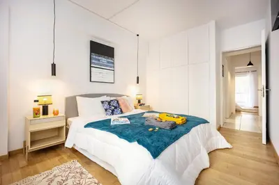a white bedroom with a bed with a blue blanket at Acropolis Retreat Stay in Style in Athens
