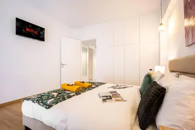 a bedroom with a bed with yellow pillows on it at Acropolis Retreat Stay in Style in Athens