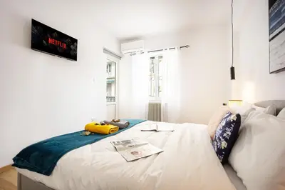 a bedroom with a large white bed in a room at Acropolis Retreat Stay in Style in Athens